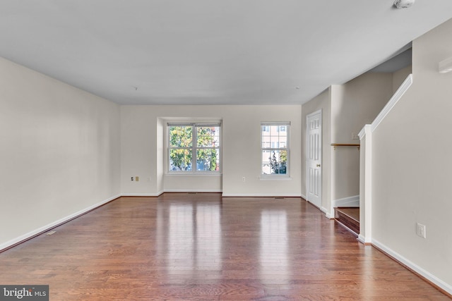 unfurnished living room with hardwood / wood-style flooring