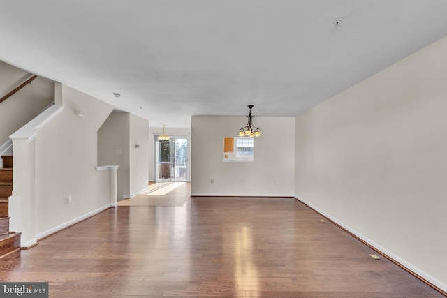 interior space featuring hardwood / wood-style floors and a notable chandelier