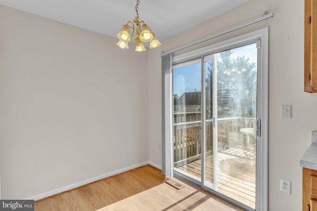 interior space featuring a notable chandelier and light hardwood / wood-style flooring