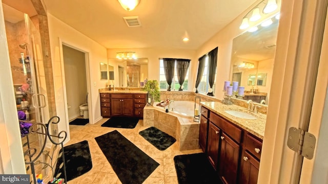 full bathroom with vanity, toilet, tile patterned floors, and separate shower and tub