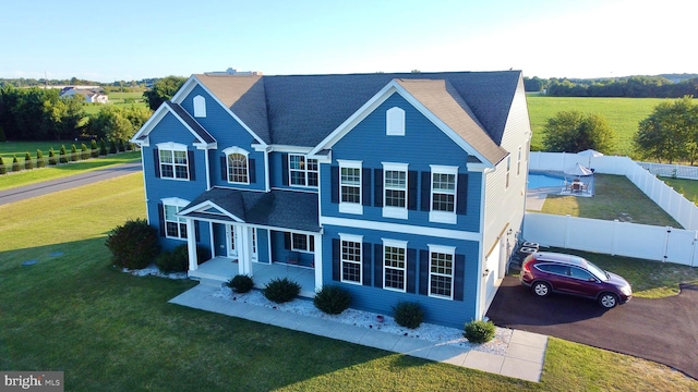 view of front facade with a front yard and covered porch