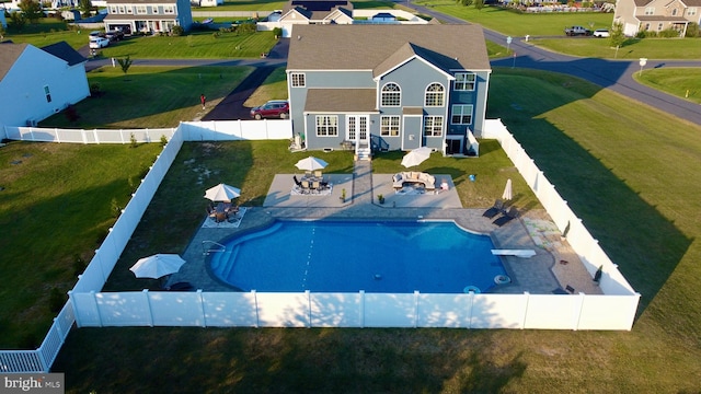 view of swimming pool featuring a yard and a patio