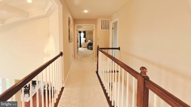 hall with light colored carpet