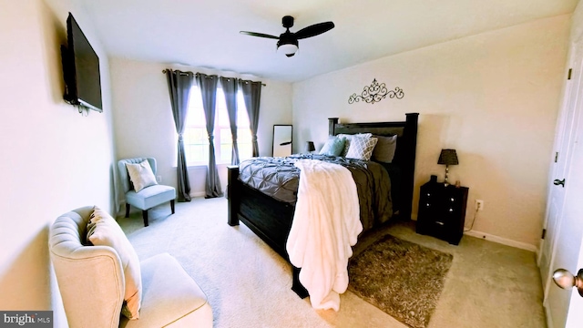 bedroom with ceiling fan and light carpet