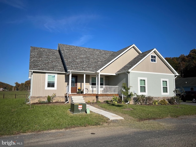 view of front facade with a front lawn and covered porch