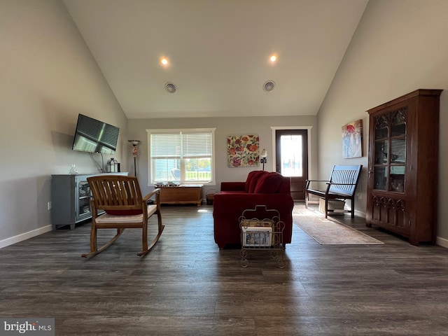 living room featuring a healthy amount of sunlight, high vaulted ceiling, and dark wood-type flooring