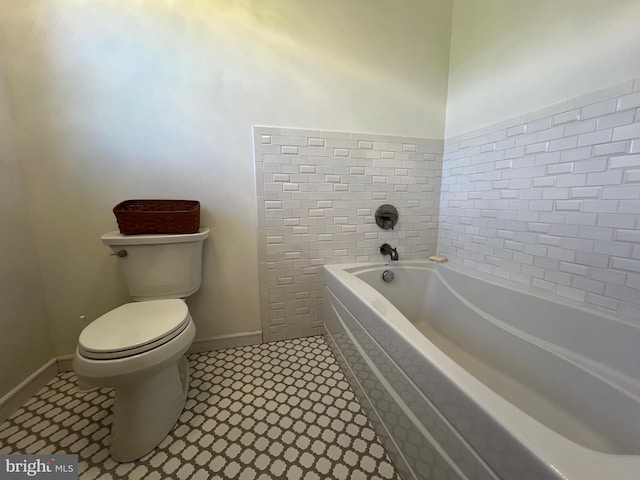 bathroom featuring toilet, a bathing tub, and tile patterned flooring