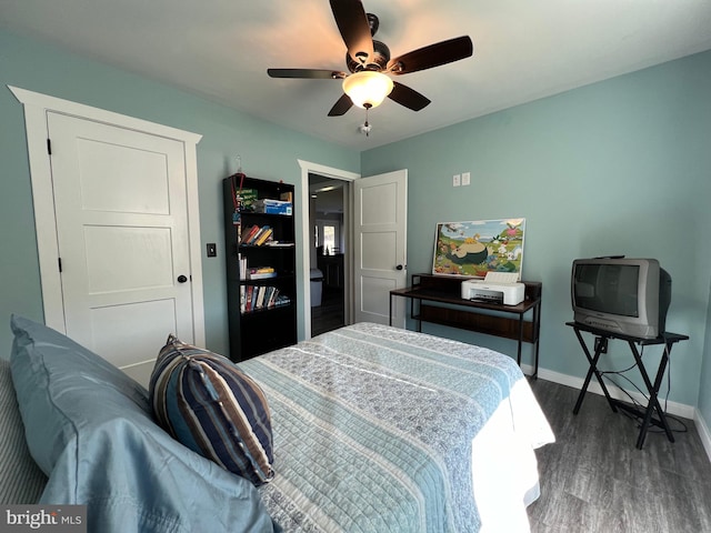 bedroom featuring dark hardwood / wood-style floors and ceiling fan