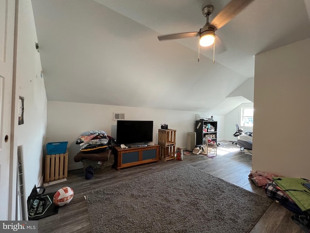 additional living space featuring radiator heating unit, ceiling fan, wood-type flooring, and vaulted ceiling