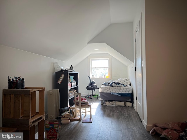 bedroom featuring dark wood-type flooring and vaulted ceiling