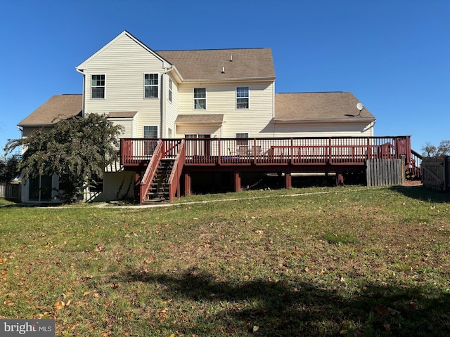 back of property featuring a lawn and a deck