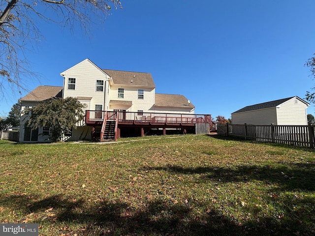 rear view of property with a deck and a lawn