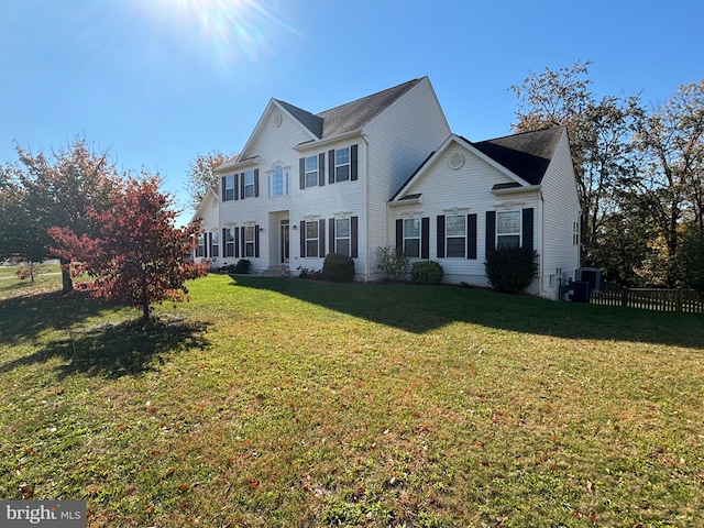 view of front of property with central air condition unit and a front yard