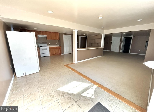 kitchen featuring ornate columns, light colored carpet, and white appliances