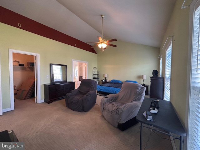 carpeted bedroom with a walk in closet, a closet, high vaulted ceiling, and ceiling fan