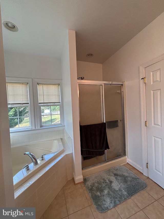 bathroom featuring tile patterned flooring and separate shower and tub