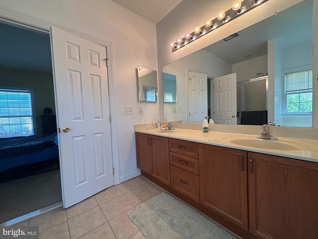 bathroom with walk in shower, vanity, tile patterned floors, and plenty of natural light