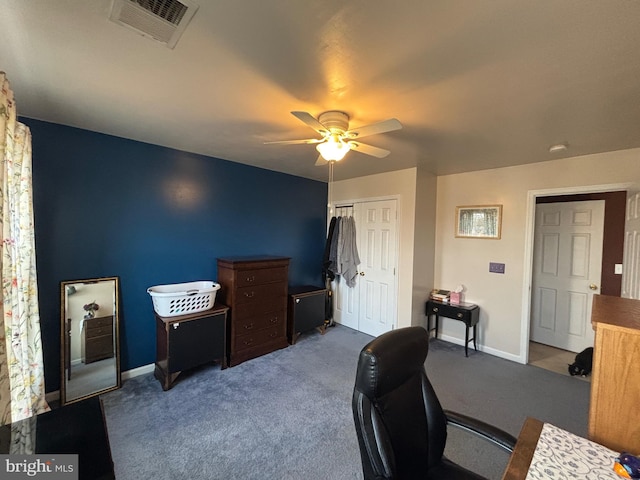 carpeted office space featuring ceiling fan