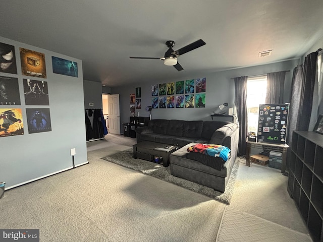 carpeted living room featuring ceiling fan