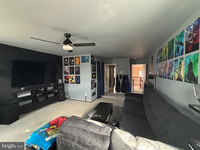 carpeted living room with ceiling fan