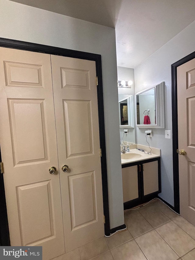 bathroom with tile patterned flooring and vanity