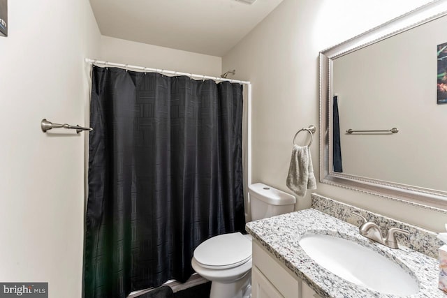 bathroom featuring vanity, toilet, and a shower with shower curtain