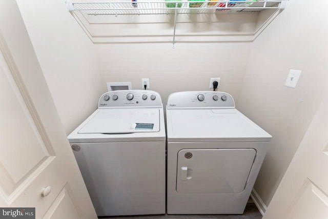 clothes washing area featuring washer and clothes dryer