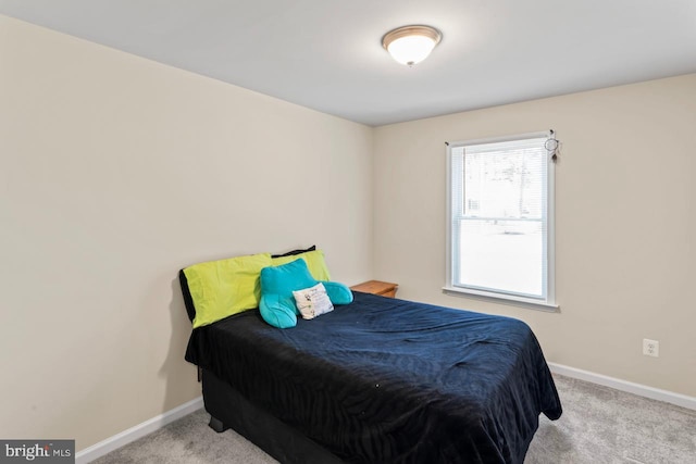 bedroom featuring light carpet