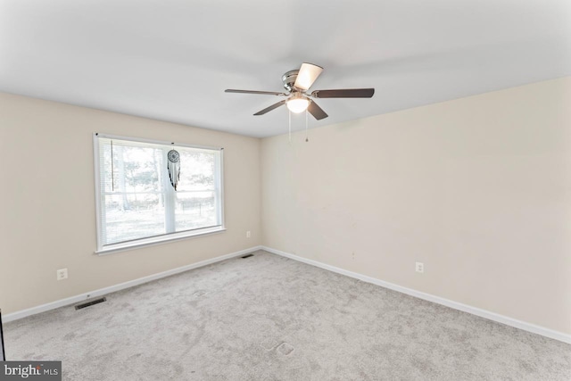 carpeted empty room featuring ceiling fan