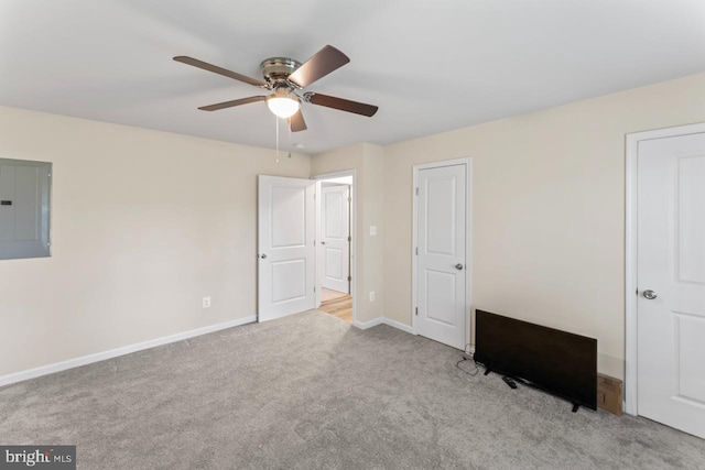 unfurnished bedroom featuring ceiling fan, light carpet, and electric panel