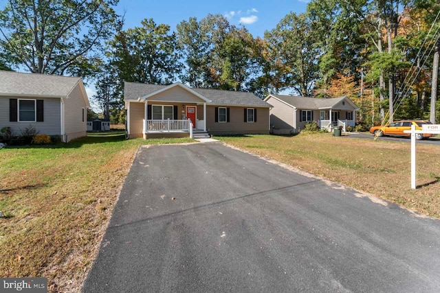 ranch-style home with covered porch and a front lawn