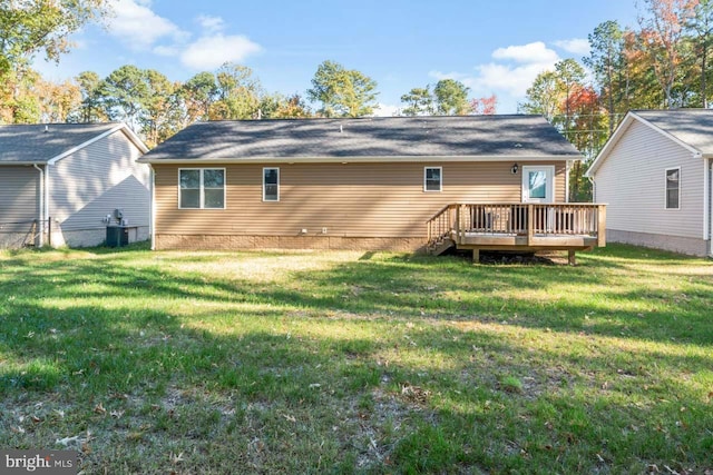 back of property featuring a wooden deck, a yard, and central AC unit