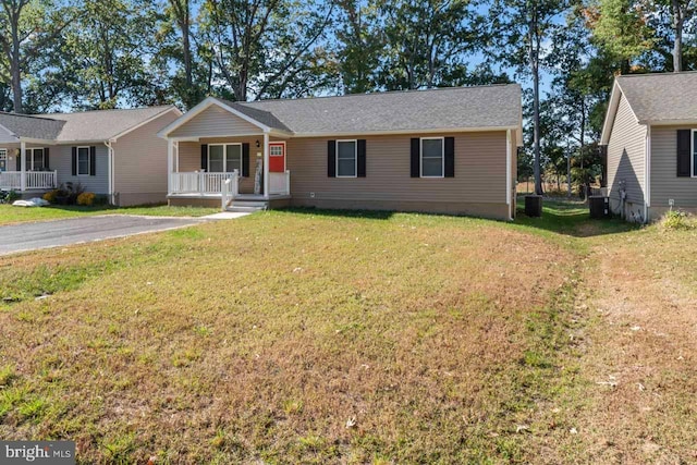 single story home with a porch and a front lawn