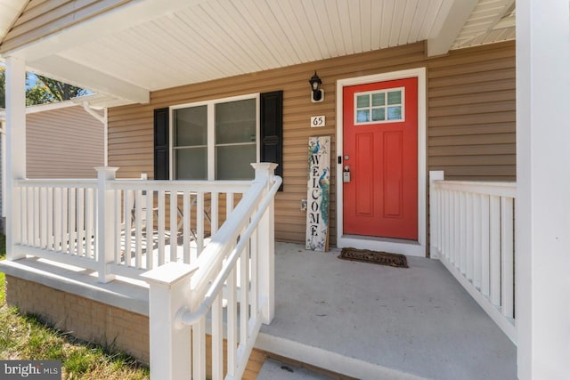 view of exterior entry featuring a porch