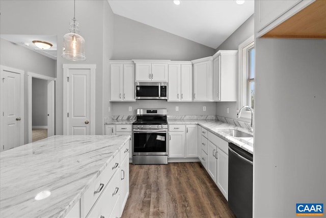 kitchen featuring sink, vaulted ceiling, stainless steel appliances, and white cabinetry