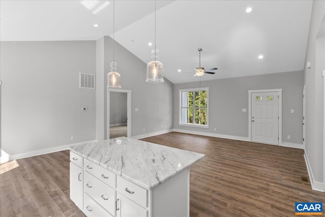 kitchen with a center island, hanging light fixtures, white cabinetry, ceiling fan, and dark wood-type flooring