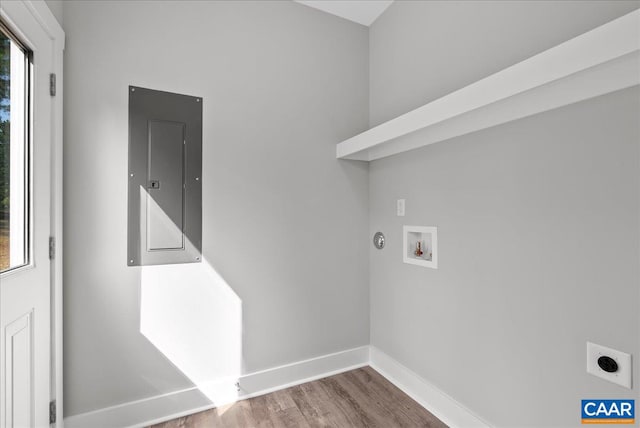 washroom featuring electric panel, hardwood / wood-style flooring, washer hookup, and electric dryer hookup