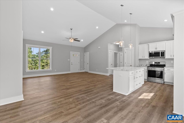 kitchen featuring hardwood / wood-style floors, a center island, stainless steel appliances, and white cabinetry