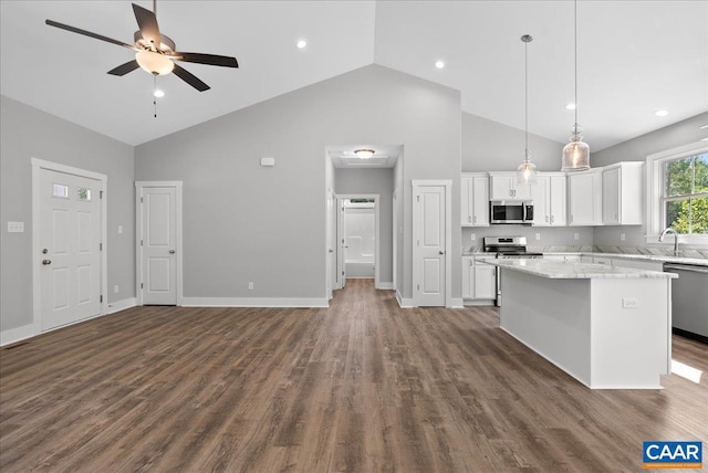 kitchen with appliances with stainless steel finishes, a kitchen island, hanging light fixtures, white cabinetry, and dark hardwood / wood-style floors