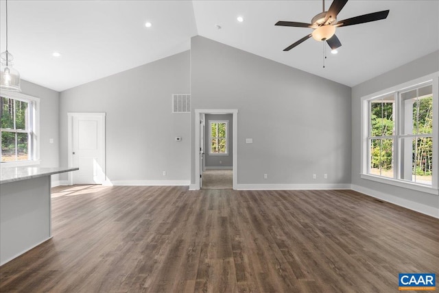 unfurnished living room with dark hardwood / wood-style floors, a healthy amount of sunlight, and ceiling fan