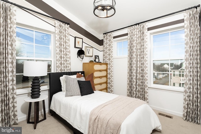 bedroom featuring light colored carpet