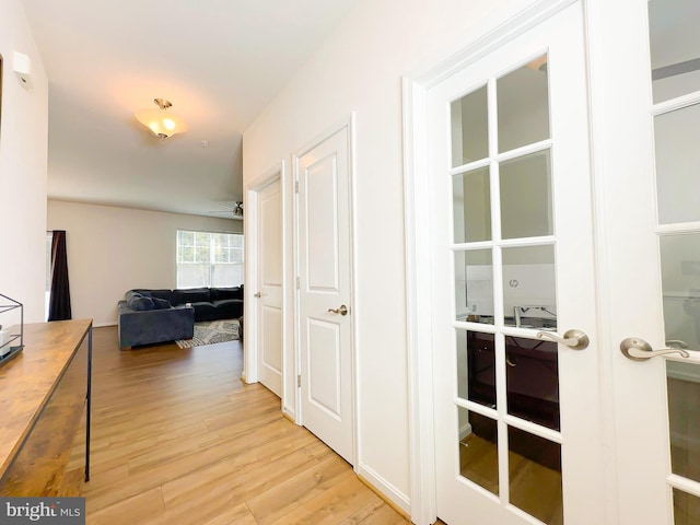 hall featuring french doors and light hardwood / wood-style floors