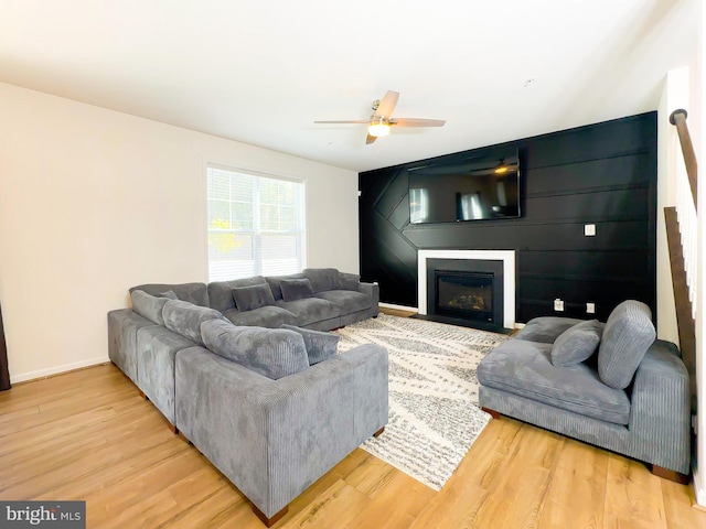 living room featuring ceiling fan and hardwood / wood-style flooring