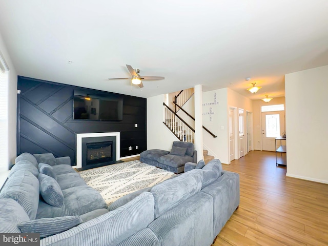 living room with ceiling fan and hardwood / wood-style flooring