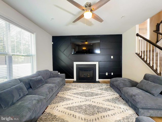 living room with wood-type flooring and ceiling fan