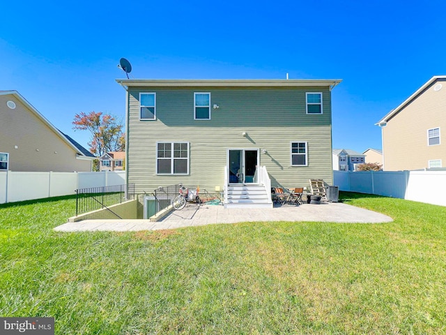 rear view of property featuring a yard and a patio area