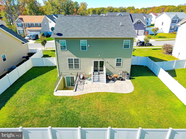 back of property featuring a patio area and a yard