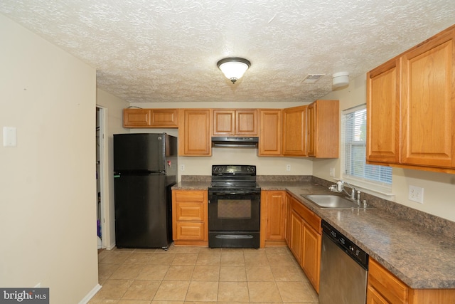 kitchen featuring black appliances, sink, light tile patterned floors, and a textured ceiling