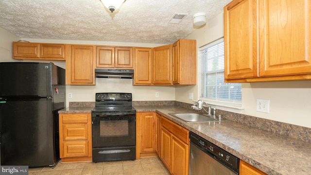 kitchen featuring black appliances, sink, a textured ceiling, and light tile patterned floors