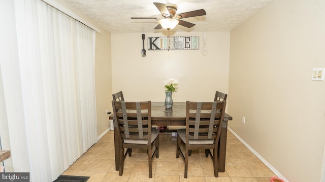 dining room featuring a textured ceiling, light tile patterned floors, and ceiling fan